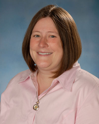 A headshot of Dr. Julie Dunning Hotopp. She is wearing a pink shirt and smiling.